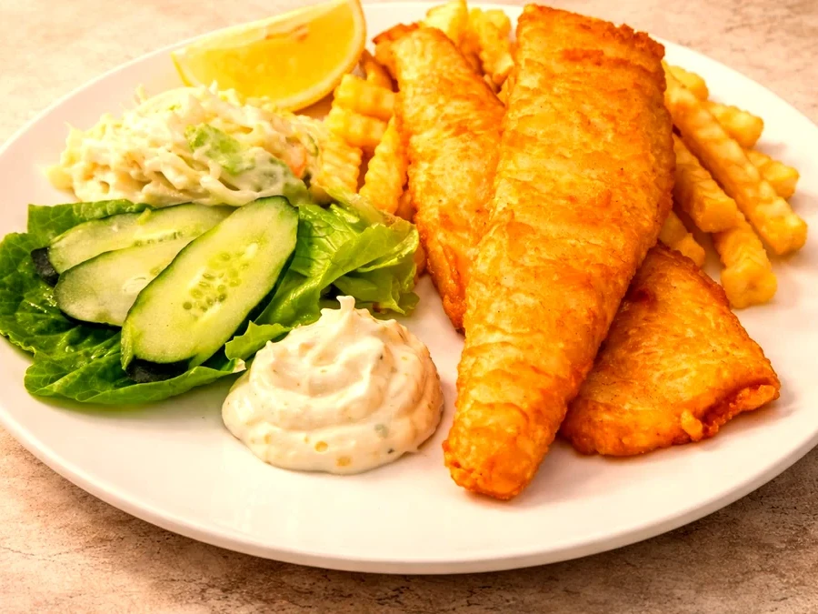 Golden beer-battered fish fillets with crinkle fries, coleslaw and tartar sauce